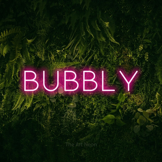 Hot pink LED neon sign reading "Bubbly" against a moss-covered green wall for bar décor