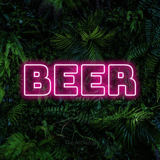 Hot pink outline-style LED neon sign reading "Beer" against a dense tropical foliage wall for bar décor
