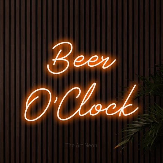Orange script-style LED neon sign reading "Beer O'Clock" against dark wooden slats for bar décor