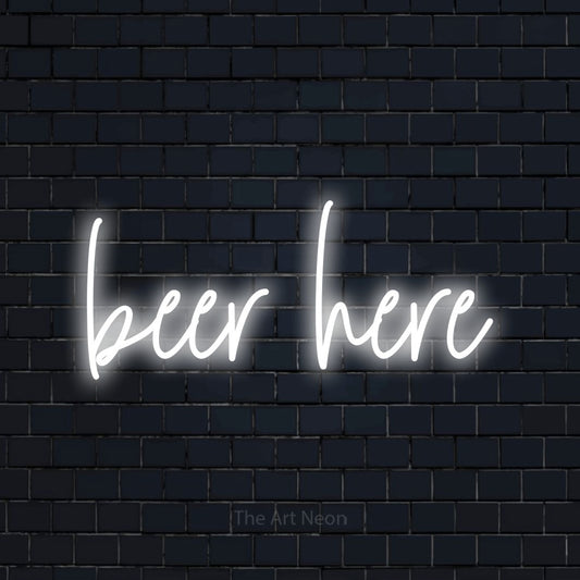 Cool white script-style LED neon sign reading "Beer Here" against a dark navy brick wall for bar décor