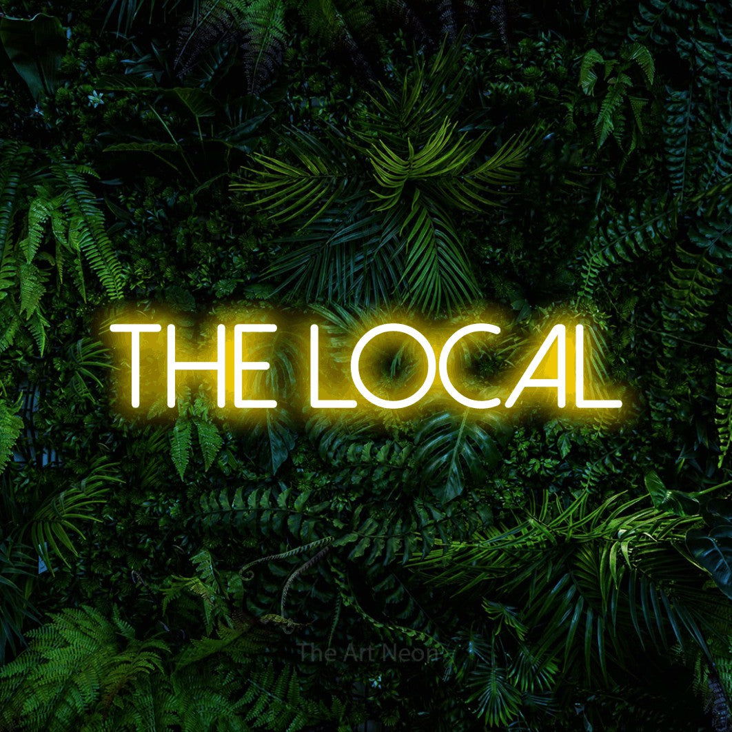 Yellow LED neon sign reading "The Local" against a dense tropical foliage wall for bar décor