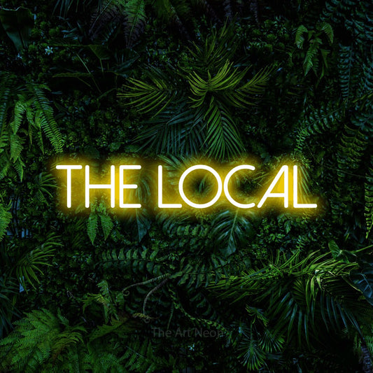 Yellow LED neon sign reading "The Local" against a dense tropical foliage wall for bar décor