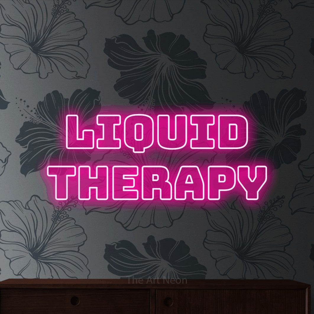 Hot pink outline-style LED neon sign reading "Liquid Therapy" against grey floral wallpaper for bar décor