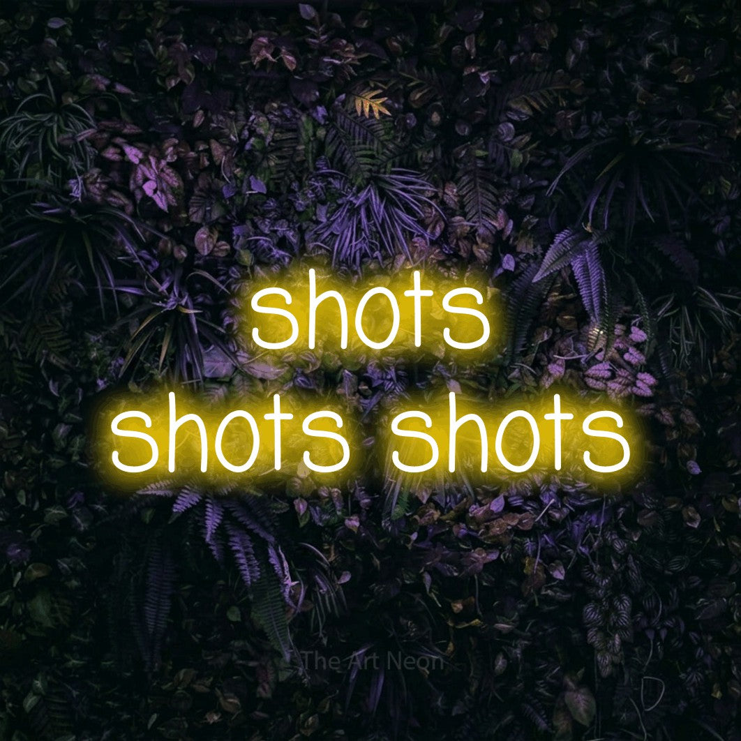 Yellow LED neon sign reading "Shots Shots Shots" against a purple floral wall for bar décor