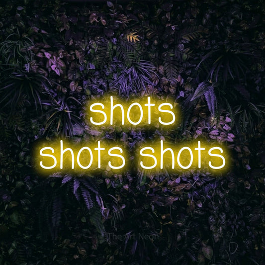 Yellow LED neon sign reading "Shots Shots Shots" against a purple floral wall for bar décor