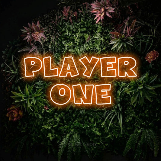 Orange outline-style LED neon sign reading "Player One" against a flowering garden wall for gaming room décor