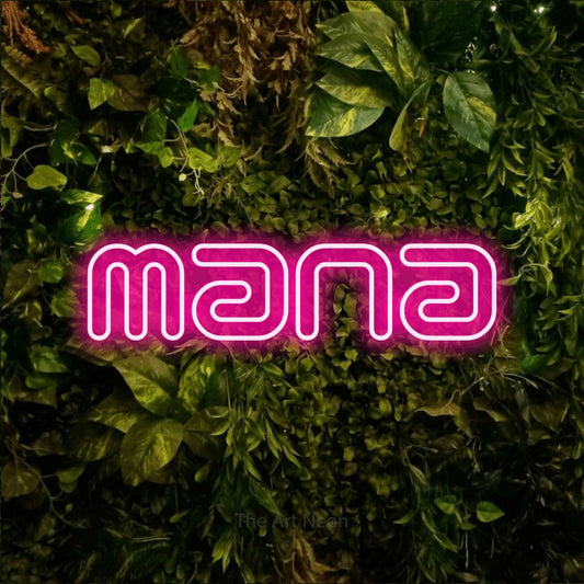 Hot pink outline-style LED neon sign reading "Mana" against a textured moss and foliage wall for gaming room décor