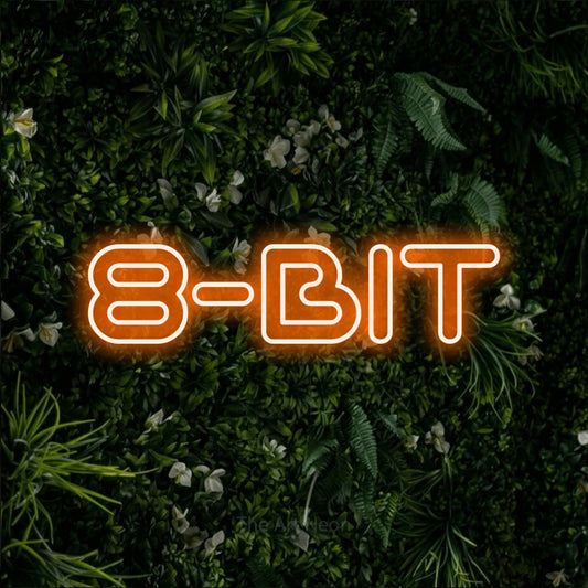 Orange outline-style LED neon sign reading "8-Bit" against a leafy green wall for gaming room décor