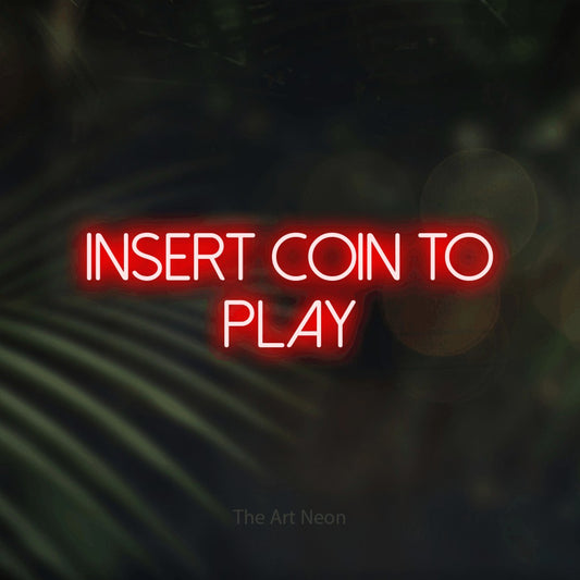 Red LED neon sign reading "Insert Coin to Play" against dark blurred palm leaves for gaming room décor