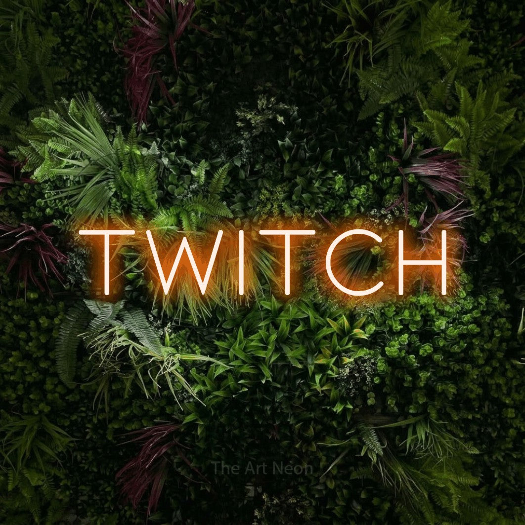 Orange LED neon sign reading "Twitch" against a lush garden wall with pink flowers for gaming room décor