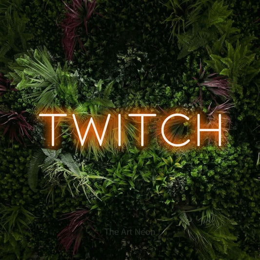 Orange LED neon sign reading "Twitch" against a lush garden wall with pink flowers for gaming room décor