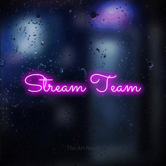 Pink LED neon sign reading "Stream Team" against a dark blue bokeh background for gaming room décor