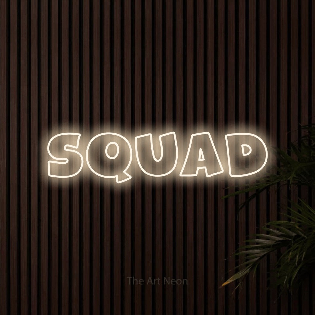 Warm white outline-style LED neon sign reading "Squad" against dark wooden slats for gaming room décor