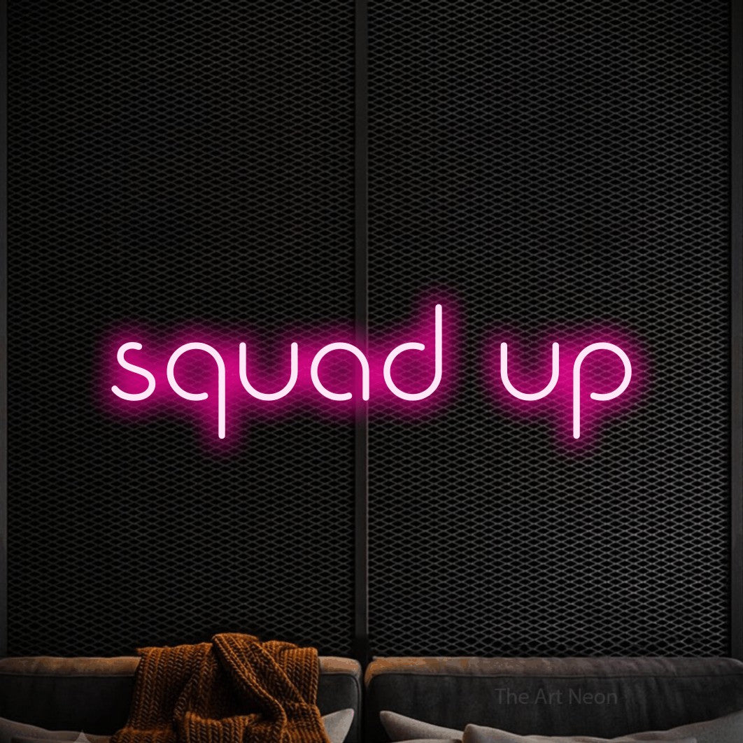 Hot pink LED neon sign reading "Squad Up" against a black textured wall for gaming room décor
