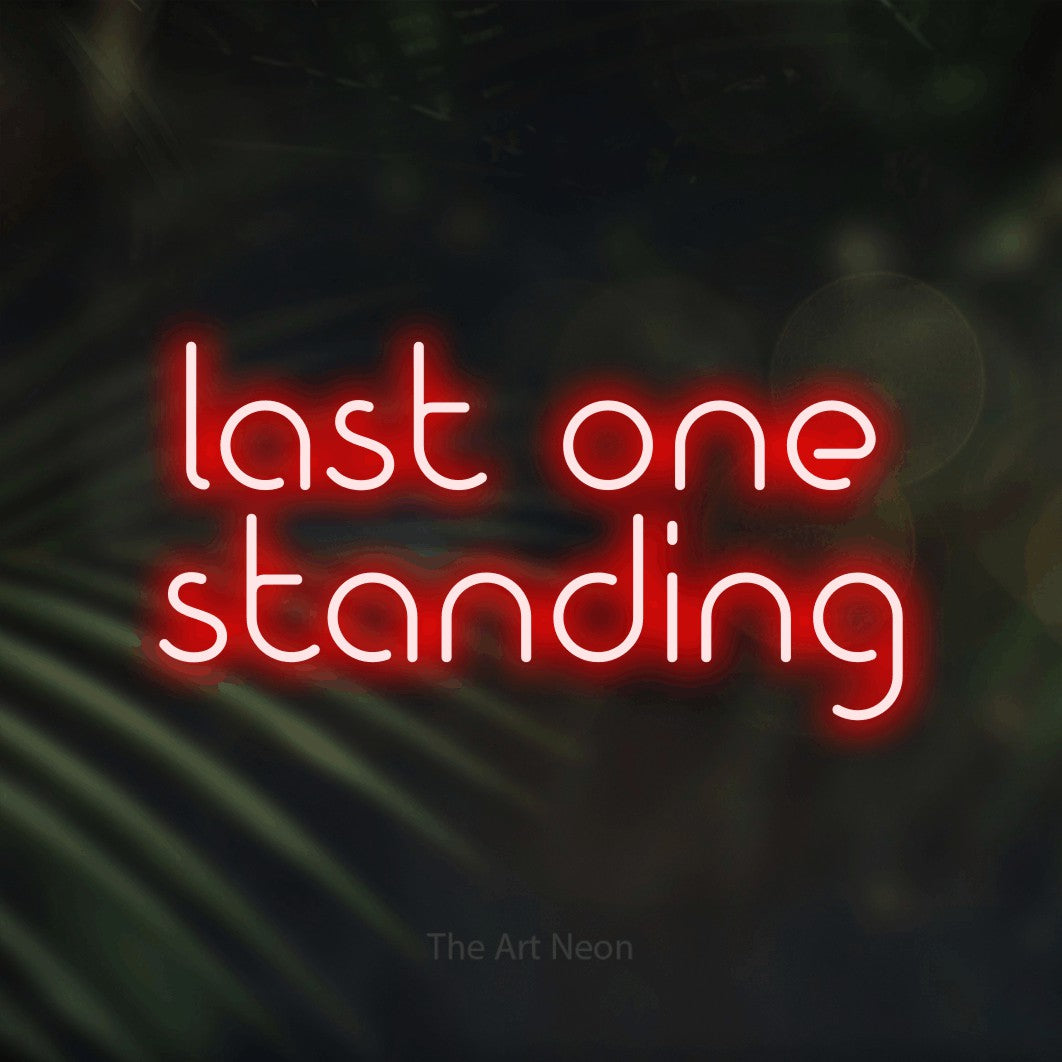 Red LED neon sign reading "Last One Standing" against dark blurred palm leaves for gaming room décor