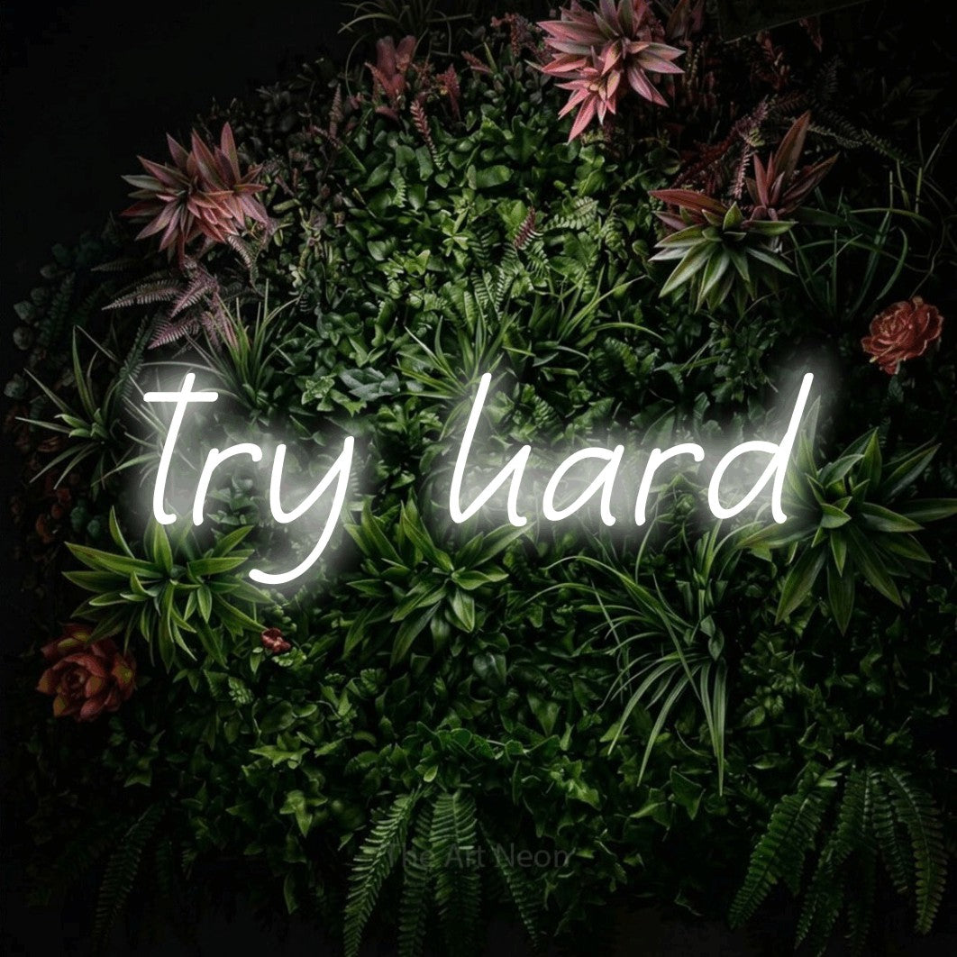 Cool white LED neon sign reading "Try Hard" against a flowering garden wall for gaming room décor