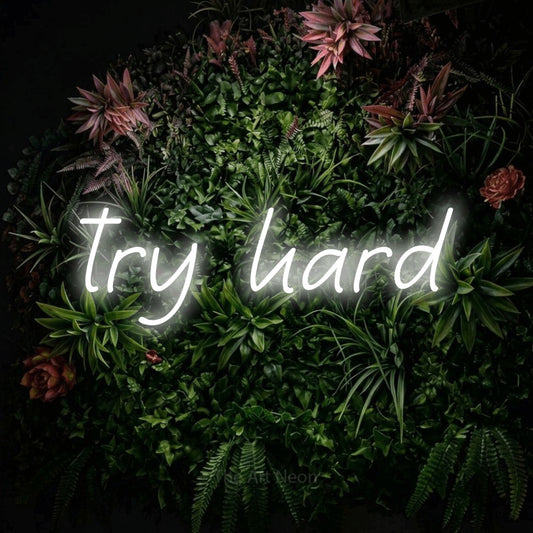 Cool white LED neon sign reading "Try Hard" against a flowering garden wall for gaming room décor