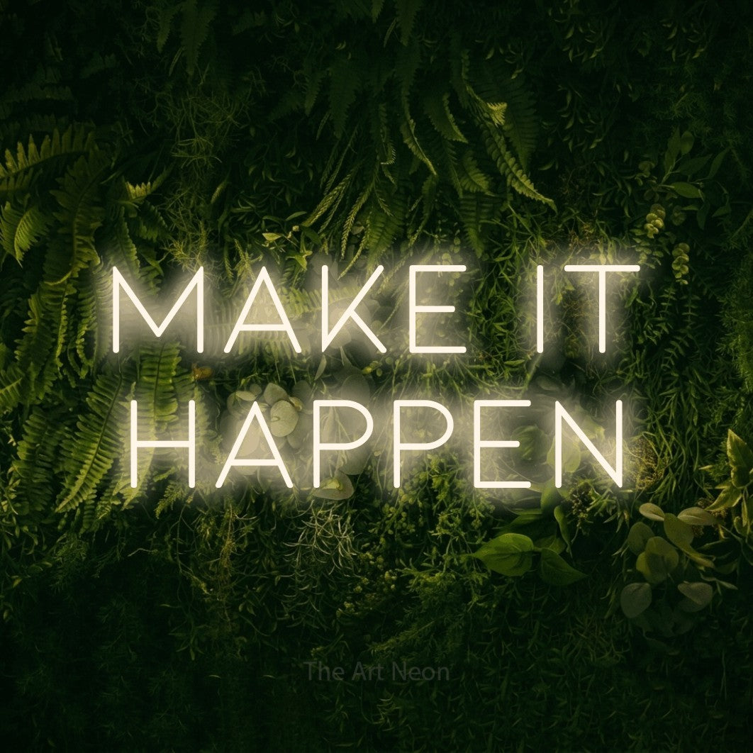 Warm white LED neon sign reading "Make It Happen" against a moss-covered green wall