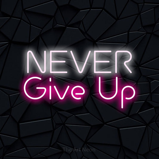 Hot pink and cool white LED neon sign reading "Never Give Up" against a black faceted wall