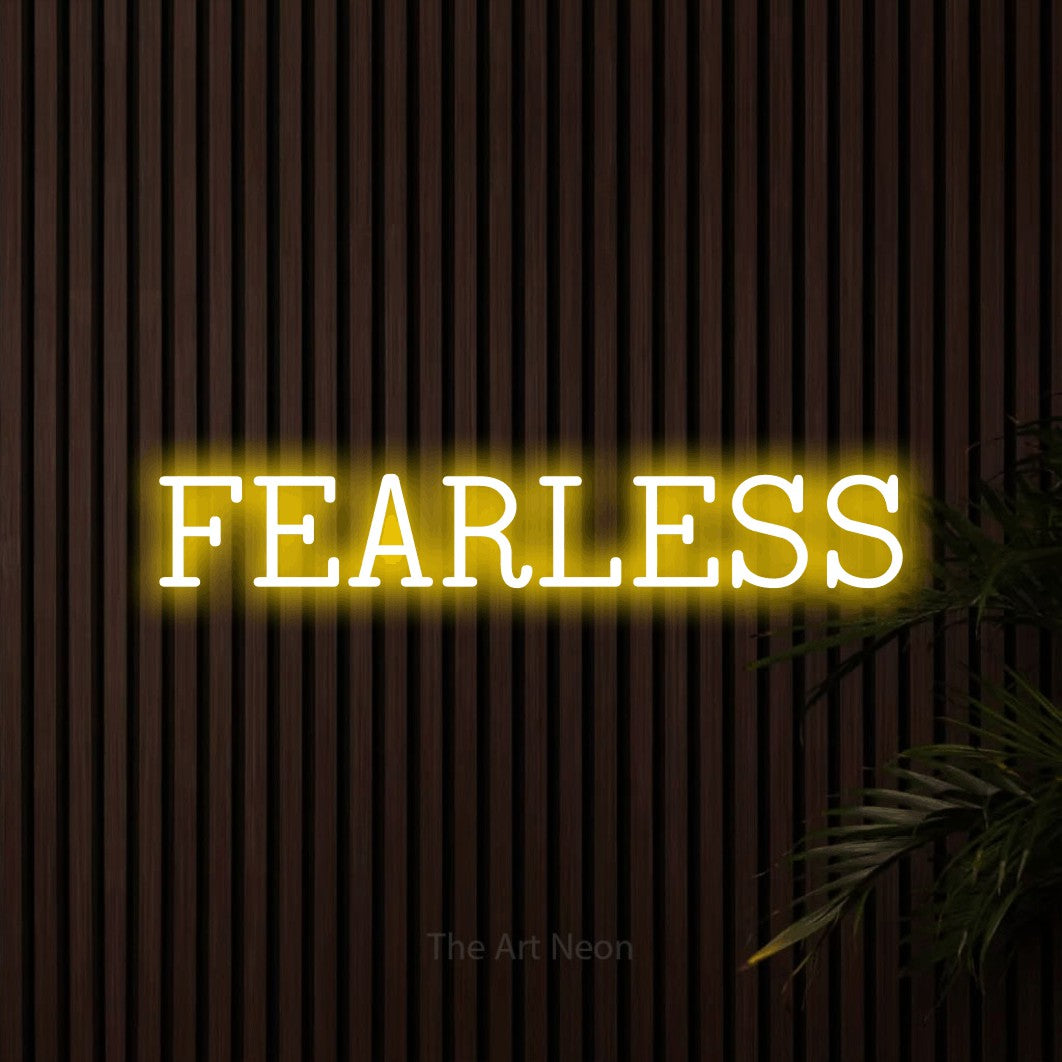 Yellow LED neon sign reading "Fearless" against dark wooden slats