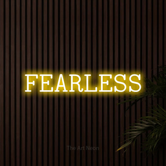 Yellow LED neon sign reading "Fearless" against dark wooden slats