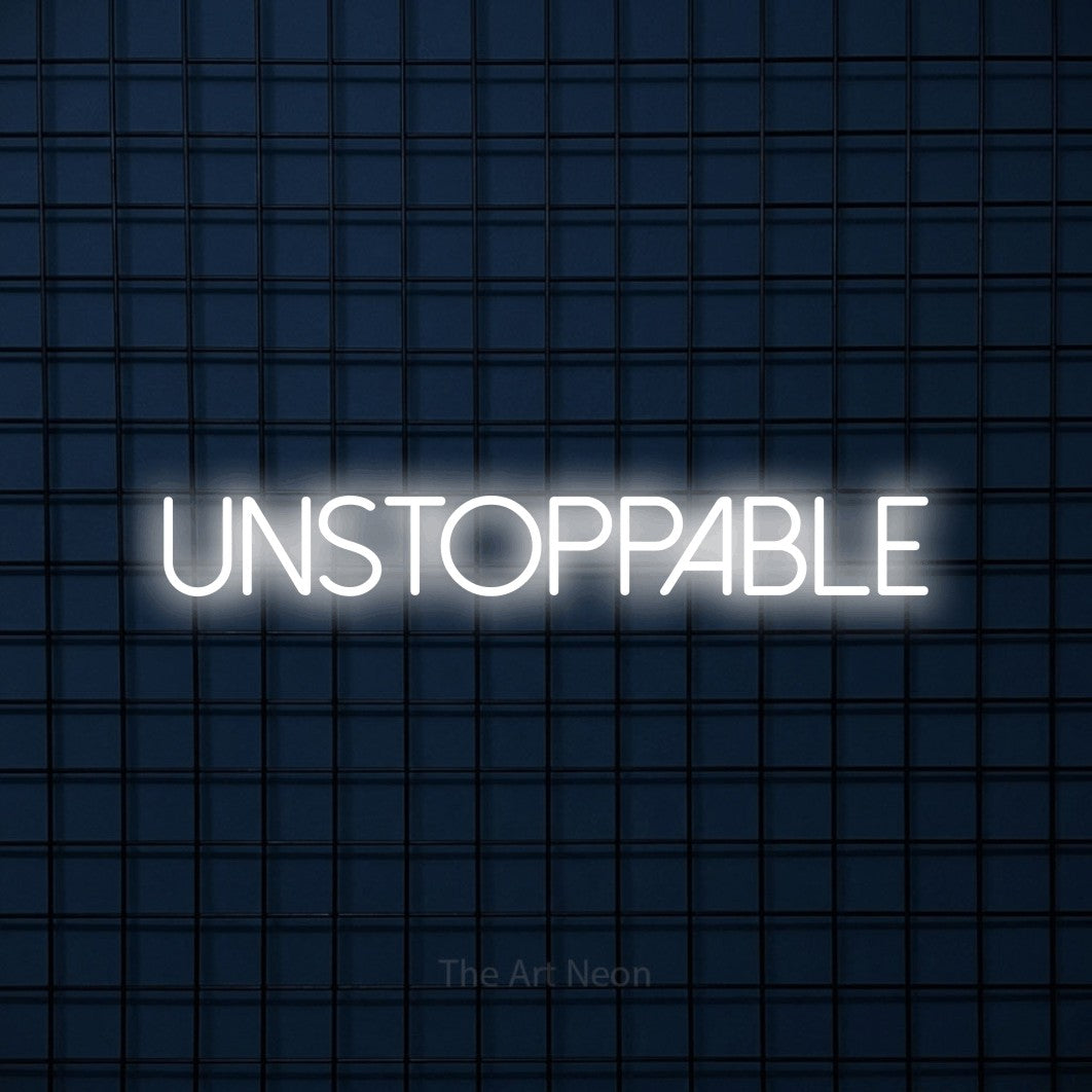 Cool white LED neon sign reading "Unstoppable" against a dark blue tiled wall