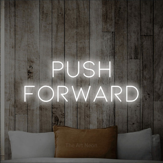 Cool white LED neon sign reading "Push Forward" against a whitewashed wooden wall