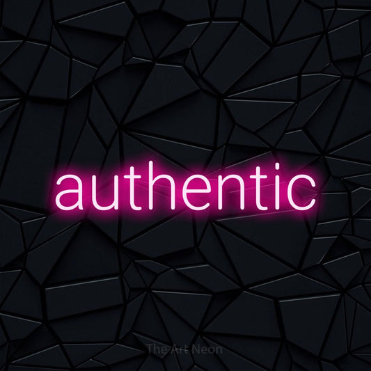 Hot pink LED neon sign reading "Authentic" against a black faceted wall