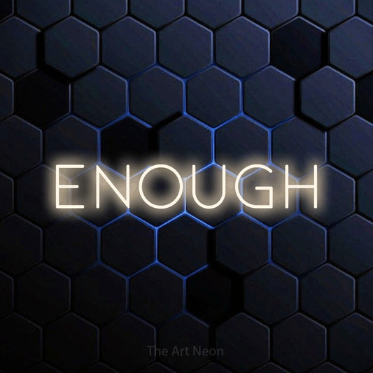 Warm white LED neon sign reading "Enough" against a blue hexagonal wall