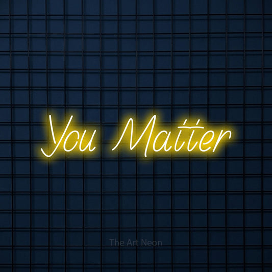 Yellow LED neon sign reading "You Matter" against a dark blue tiled wall