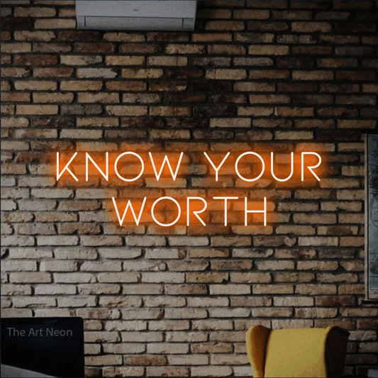 Orange LED neon sign reading "Know Your Worth" against a rustic brick wall