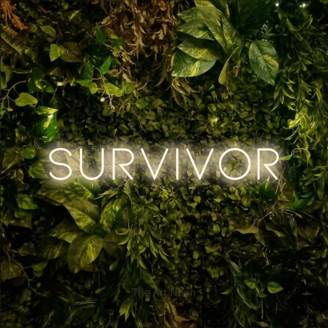 Warm white LED neon sign reading "Survivor" against a textured moss and foliage wall