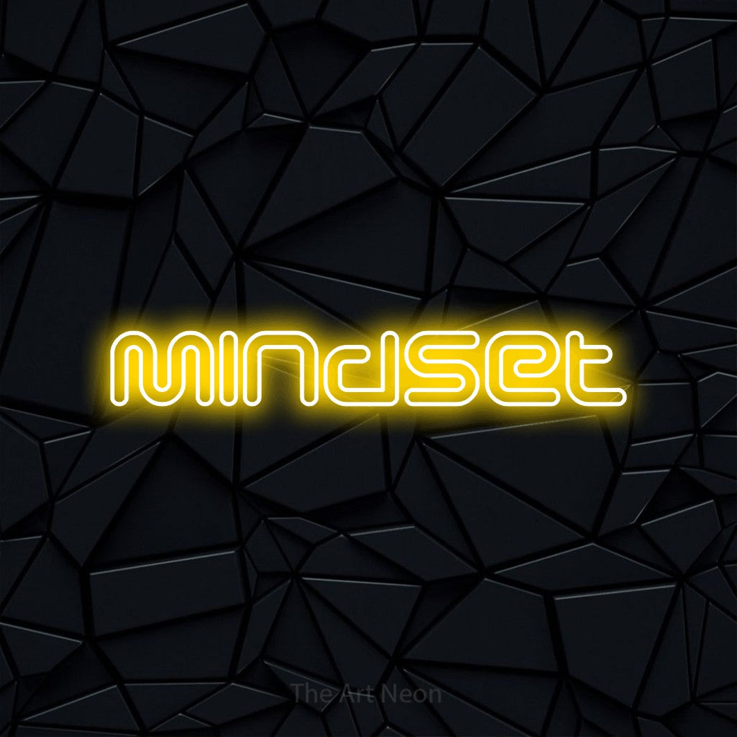 Yellow outline-style LED neon sign reading "Mindset" against a black faceted wall