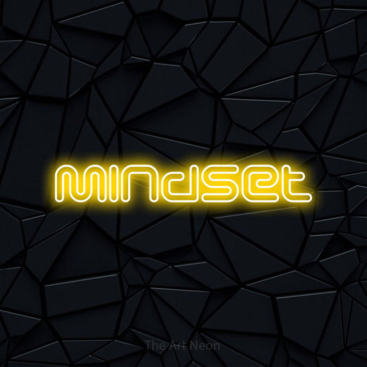 Enseigne néon à DEL à lumière jaune, de style contour, affichant « Mindset » sur un mur noir à facettes