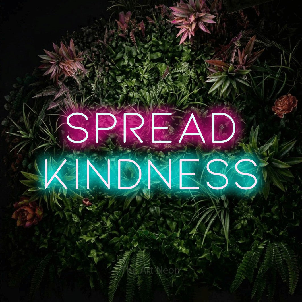 Ice blue and hot pink LED neon sign reading "Spread Kindness" against a flowering garden wall