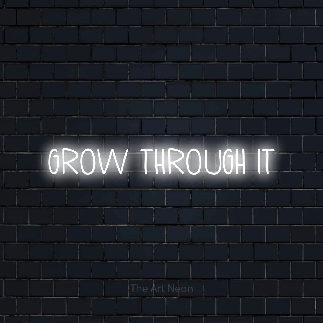 Cool white LED neon sign reading "Grow Through It" against a dark navy brick wall