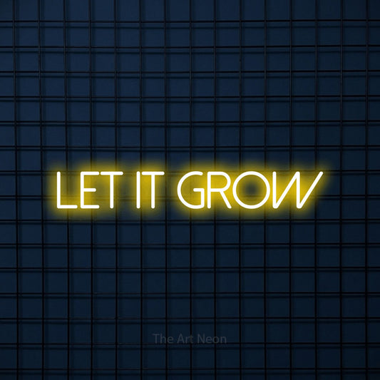 Enseigne néon à DEL à lumière jaune, affichant « Let It Grow » sur un mur carrelé bleu foncé