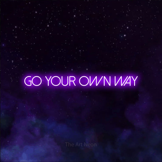 Purple LED neon sign reading "Go Your Own Way" against a purple galaxy background