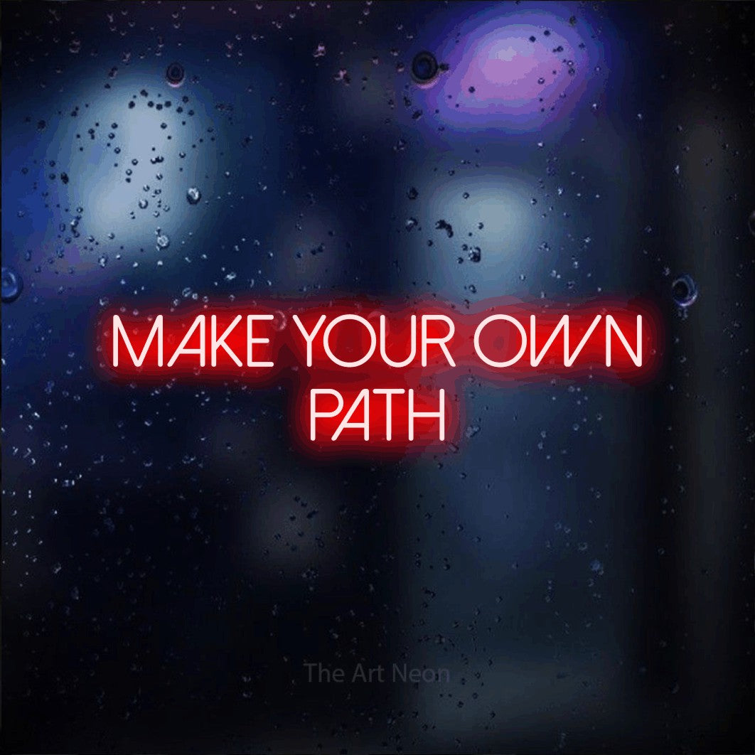 Red LED neon sign reading "Make Your Own Path" against a dark blue bokeh background