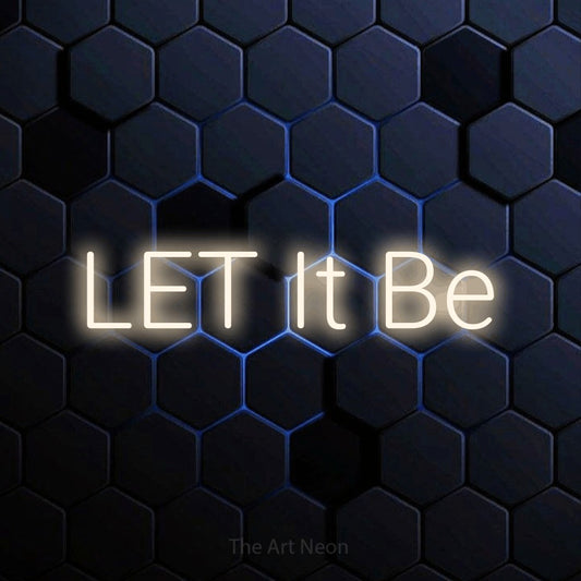 Warm white LED neon sign reading "Let It Be" against a blue hexagonal wall