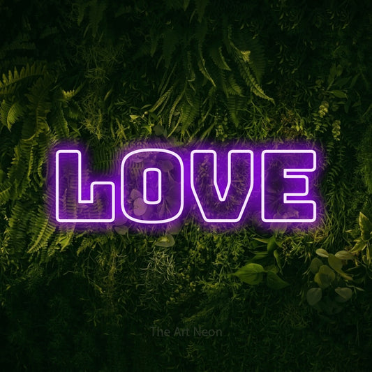 Purple outline-style LED neon sign reading "Love" against a moss-covered green wall