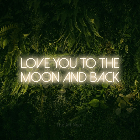Warm white LED neon sign reading "Love You to the Moon and Back" against a moss-covered green wall