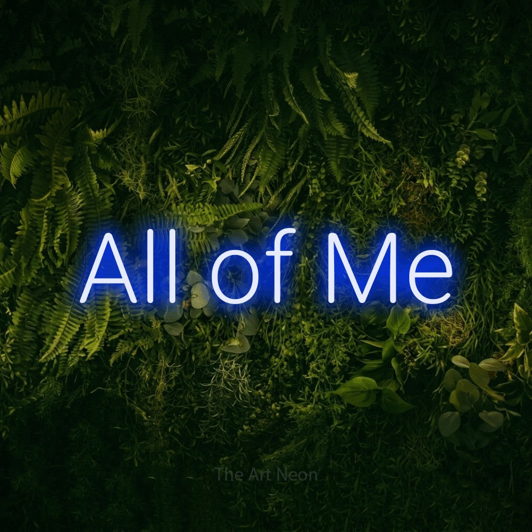 Blue LED neon sign reading "All of Me" against a moss-covered green wall