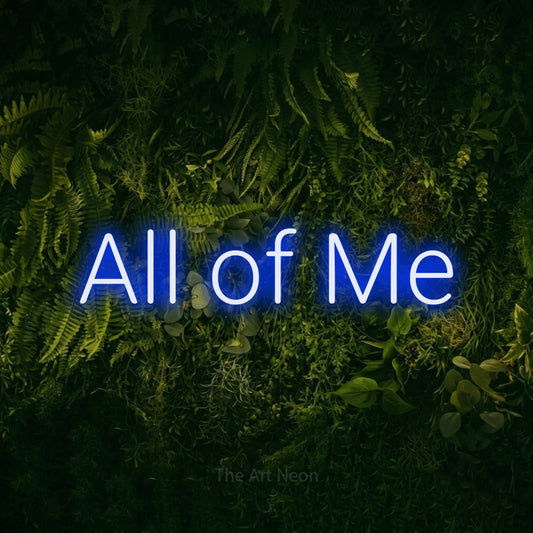 Blue LED neon sign reading "All of Me" against a moss-covered green wall