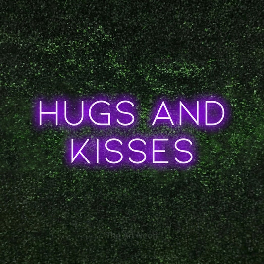 Purple LED neon sign reading "Hugs and Kisses" against a textured green moss wall