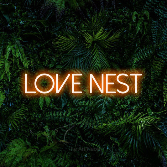 Orange LED neon sign reading "Love Nest" against a dense tropical foliage wall