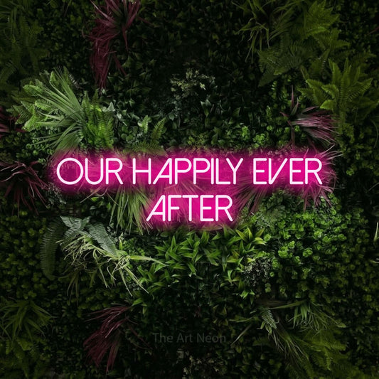 Hot pink LED neon sign reading "Our Happily Ever After" against a lush garden wall with pink flowers