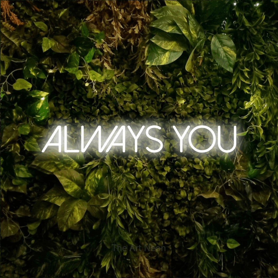 Cool white LED neon sign reading "Always You" against a textured moss and foliage wall
