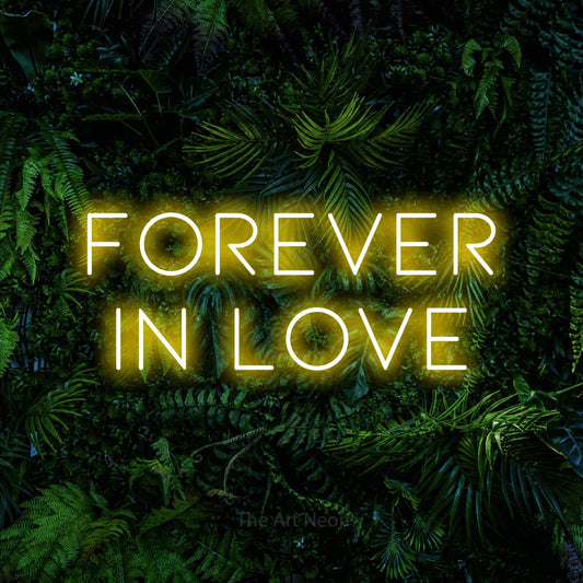 Yellow LED neon sign reading "Forever in Love" against a dense tropical foliage wall