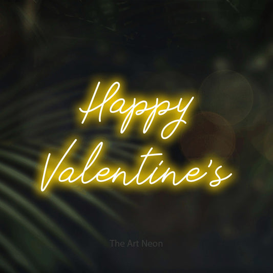 Yellow script-style LED neon sign reading "Happy Valentine's" against dark blurred palm leaves